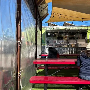 a person sitting at a picnic table
