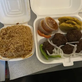 Rice and beans with fried meatballs and a side of fried plantains