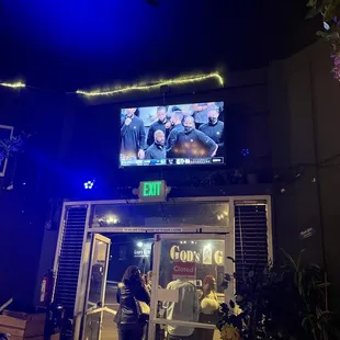 a group of people standing outside a restaurant