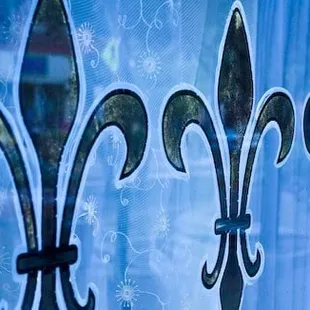 a close up of a fleur de lis window