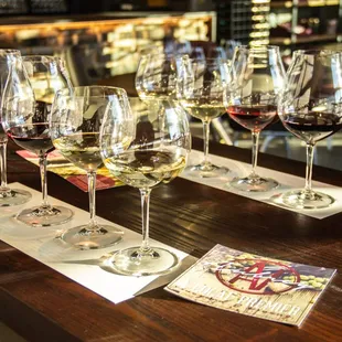 a row of wine glasses on a bar