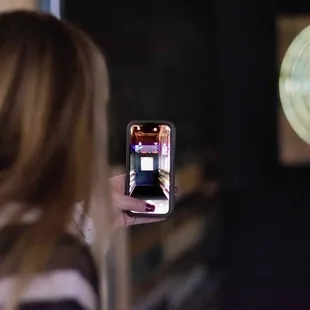 a woman holding up a cell phone