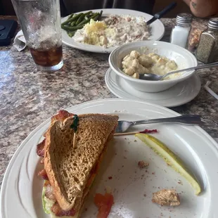 a half eaten sandwich on a plate