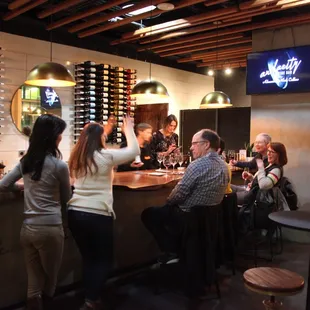 a group of people sitting at a bar