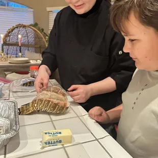 My son helping Chef Audrey prepare lobster tail