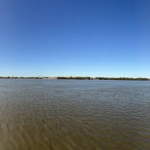 Panoramic view of the might Mississippi with a freighter navigating