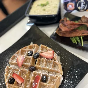 a waffle with strawberries and blueberries