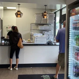 Counter and pop cooler. Very busy on a Sunday.