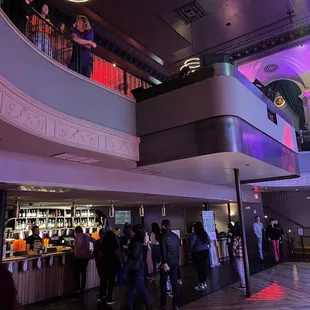 a crowd of people standing in a hall
