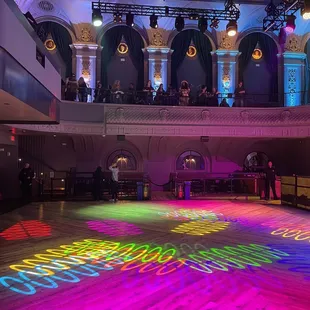 a dance floor with colored lights