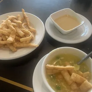 Egg drop soup with crunchy things and table mustard.
