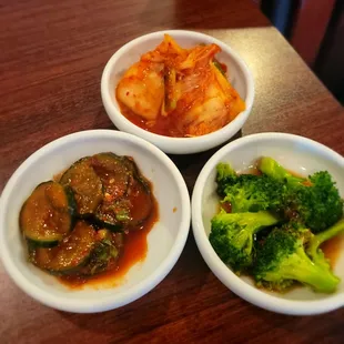 accoutrements: pickled cucumbers, broccoli and kimchee