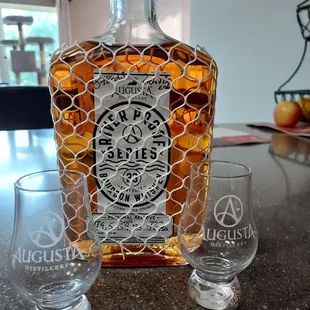 a bottle and two glasses