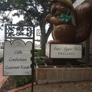 a statue of a squirrel wearing a hat