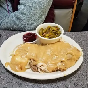 Turkey and mashed potatoes covered with brown gravy. Can beans and can cranberry sauce.