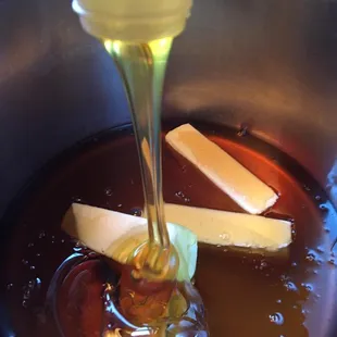 honey being poured into a pot