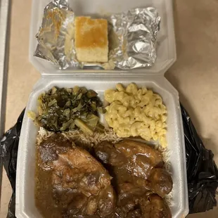 Smothered Pork Chops, Mac n cheese, and greens.