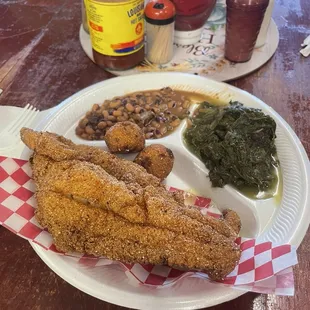 Two catfish fillets, collards and purple hulled peas.