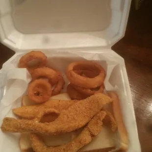 fried fish and onion rings in a styrofoam container