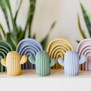 a row of colorful ceramic cactuses
