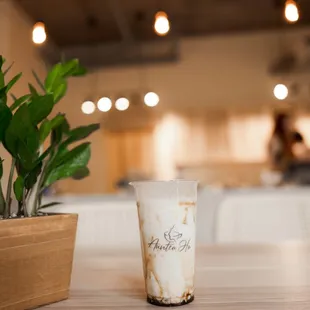 a coffee cup and a plant on a table