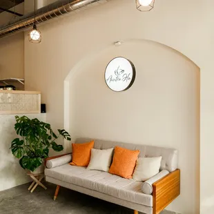 a living room with a couch and potted plant