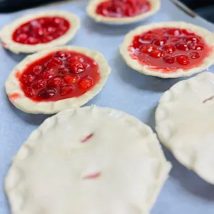 Personal sized cherry pies being topped and about to go in the oven!