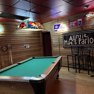 a pool table and neon signs