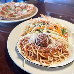 two plates of spaghetti and meatballs