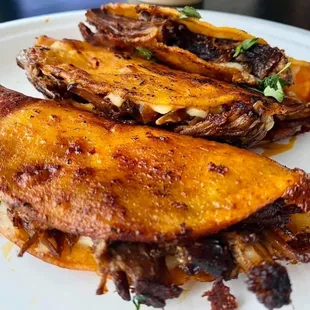 A fan favorite! Birria Quesotacos with consomé.