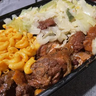 Brown stew chicken with cabbage and mac and cheese