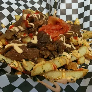 a plate of fries with meat and sauce