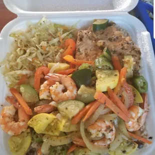 Jerk salmon and shrimp with mixed veggies, cabbage and rice n peas.