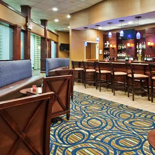 the bar and lounge area of a hotel