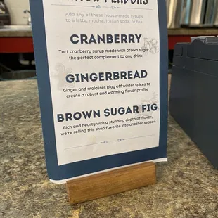 a sign on a counter in a coffee shop