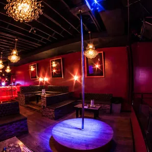 the interior of a nightclub with purple lighting