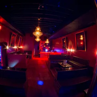 the interior of a nightclub with red and blue lighting