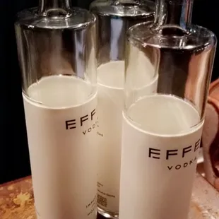 a close up of three empty bottles of vodka