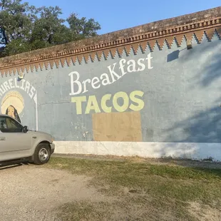 a truck parked in front of a restaurant