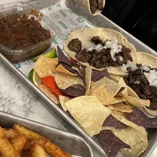 a tray of tacos and fries