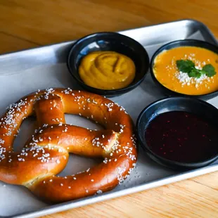 a pretzel, sauces and dips