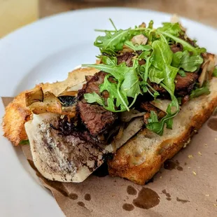 February 19, 2023; Bone marrow with beef short ribs, mushrooms, sourdough crostino ($24).