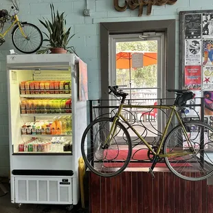 a bicycle parked in front of a vending machine