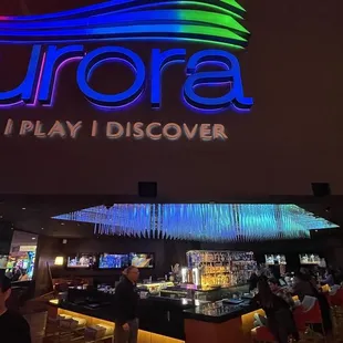 the front of a casino with neon signs