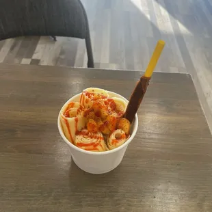 a bowl of pasta with a wooden spoon