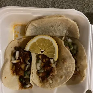 Birria taco, chicken tacos (one red sauce, one green sauce), bean taco