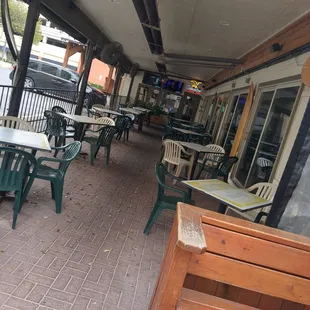 Outside, covered seating with two tvs.