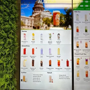 a menu of drinks displayed on a wall