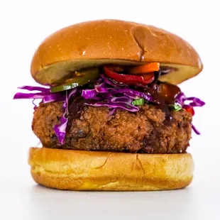 a chicken burger with coleslaw and pickles
