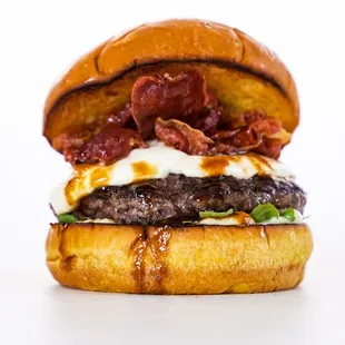 a burger with bacon, cheese, and lettuce